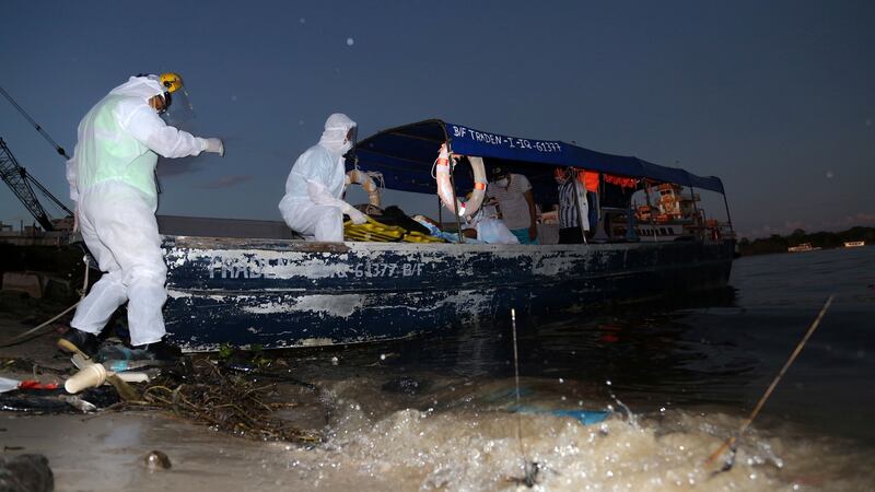 An 11-year-old Covid-19 patient arrives on a boat from a nearby community at a port in the Amazon River, in Iquitos, Loreto region, Peru, on June 18, 2020, to be transferred to the regional hospital of the city. Photograph: Cesar Von Bancels / AFP via Getty Images