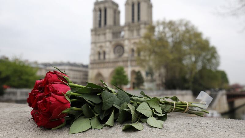 Roses laid near Notre Dame  a day after a fire devastated the cathedral in central Paris. Photograph: Ludovic Marin/AFP/Getty