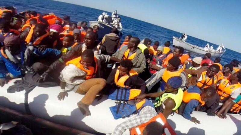 A handout video grab released by the Italian Coast Guard  on Saturday  showing some of 220 shipwrecked migrants being rescued by the Italian coast guard. Photograph: AFP