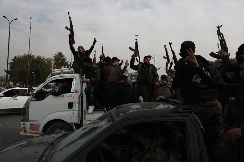 People wave guns in the air as they gather to celebrate the fall of the Syrian regime, in Umayyad Square, in Damascus, Syria. Photograph: Ali Haj Suleiman/Getty Images