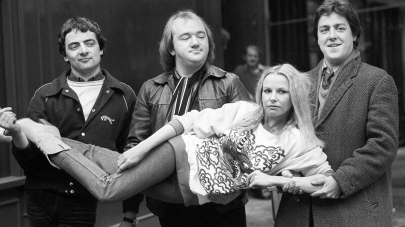 The Not the Nine O’Clock News team in 1980: (from left) Rowan Atkinson, Mel Smith, and Griff Rhys Jones carrying Pamela Stephenson. Photograph: PA Wire