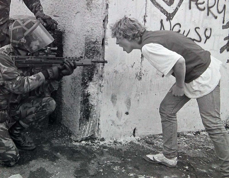 Photograph by Paul Faith: It was August 1989, the 20th anniversary of the outbreak of the Troubles and there was lots of talk in Belfast that the violence was coming. I went up to Ballymurphy and there were people squaring up to the soldiers. The squaddies were on edge – one in particular was crouchingand looking right down the street into Ballymurphy with his SA80 pointed. A woman came up and shouted right down the barrel of the gun. Although there was no physical contact  you could see the venom and hate between the republicans and the soldiers