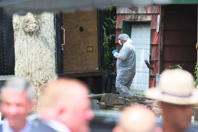 Law enforcement officials are seen as they investigate the home of Rex Heuermann. Photograph: Michael M. Santiago/Getty Images