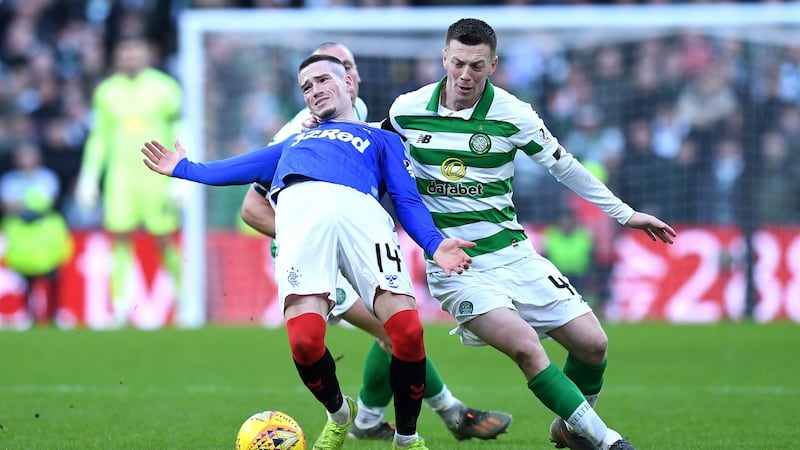 Callum McGregor tackles Ryan Kent during Caltic’s defeat to Rangers. Photograph: Mark Runnacles/Getty