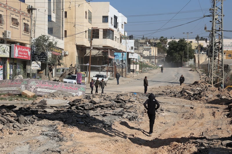 Palestinians walk on an unearthed road after a raid by Israeli forces, in the Fara camp for Palestinian refugees near Tubas in the north of the occupied West Bank on Tuesday. Photograph: Zain Jaafar/AFP via Getty