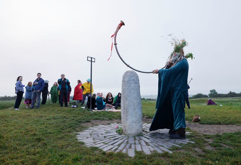 Solstice participants gather around the Lia Fail standing stone on the Hill of Tara on Wednesday morning. Photograph: Alan Betson/The Irish Times

