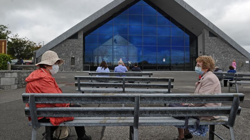 Visitors wearing face masks at Knock Shrine, Co Mayo. Photograph: Conor McKeown