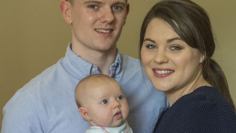 Claire Woods, her partner, Peter, and their baby girl, Alexandra. Photograph: Brenda Fitzsimons