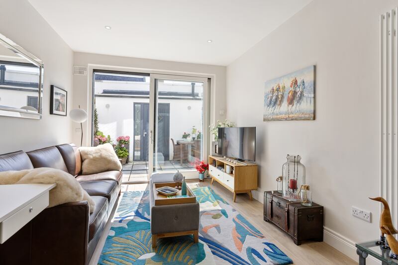 The living area connects to the rear patio garden. Photograph: Angela Mujica