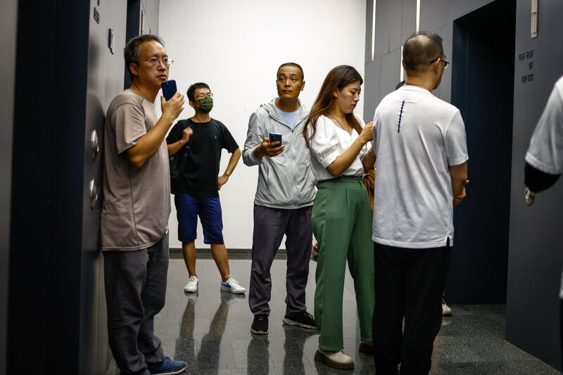 People wait for an elevator. The National Bureau of Statistics  has stopped releasing unemployment rates, citing the need to improve labour statistics. Photograph: Mark R Cristino/EPA