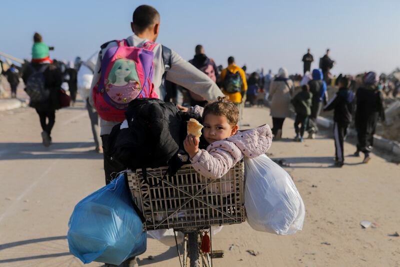 Displaced Palestinians walk along Gaza's Al-Rashid coastal street to cross the Netzarim Corridor from the southern Gaza Strip to the north on Monday. Photograph: Saeed Jaras/Middle East Images/AFP via Getty Images