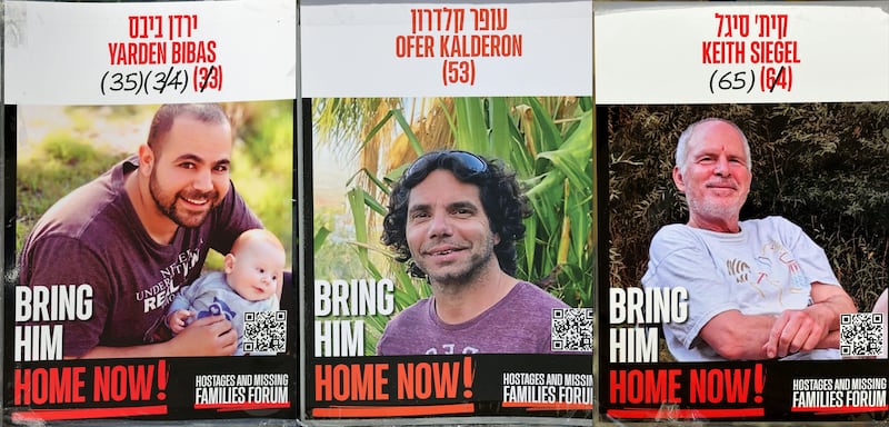 Posters of three Israeli hostages held in Gaza and now released: Yarden Bibas (L), Ofer Kalderon and Keith Siegel (R). Photograph: AFP via Getty Images