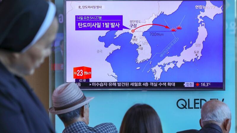 People watch a news programme showing a graphic of a North Korean missile launch, at a railway station in Seoul on Sunday. Photograph: AFP Photo/Yonhap