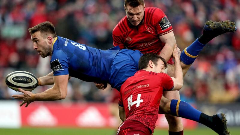 Leinster’s Jack Conan is  tackled by Rory Scannell and Darren Sweetnam of Munster during the Guinness Pro 14 game atb Thomond Park. Photograph: Dan Sheridan/Inpho