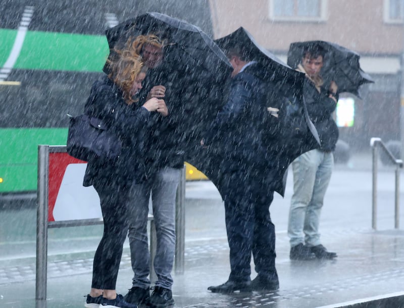 Commuters on Store Street, Dublin, get caught in a torrential rain shower ahead of Storm Ashley. Photograph: Colin Keegan, Collins Dublin