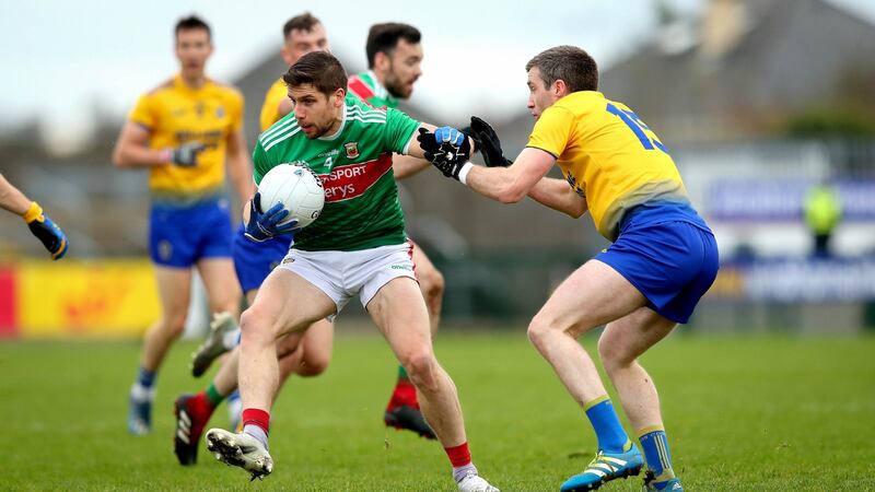 Roscommon’s Cathal Cregg tackles Lee Keegan. Photo: Ryan Byrne/Inpho