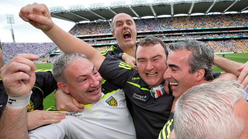 Donal Reid (left) and Joe McCloskey celebrate with Donegal manager Jim McGuinness after the victory over Dublin in the 2014 All-Ireland semi-final at Croke Park. Photograph: Morgan Treacy/Inpho