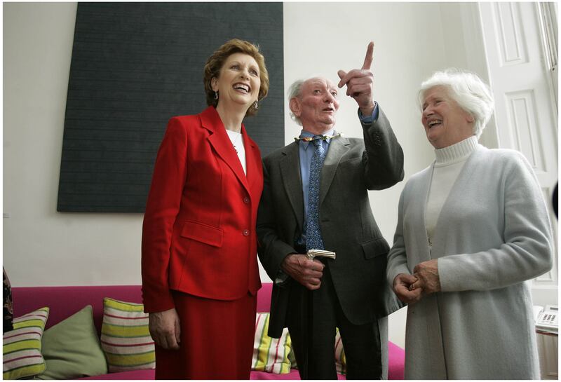 Then president Mary McAleese, after presenting Brian Friel with the gold Torc, to mark his election as Saoi in Aosdána in 2006, with his wife Anne. 
Photograph: Dara Mac Dónaill 