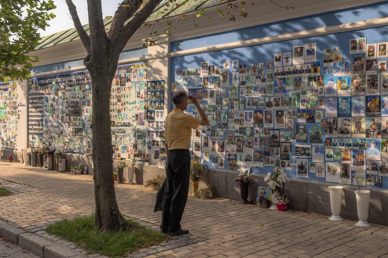 A man makes the sign of the cross as he pays respect in front of 'The memory wall of fallen defenders of Ukraine in the Russian-Ukrainian war' in Kyiv on July 25th. Photograph: Roman Pilipey/AFP via Getty