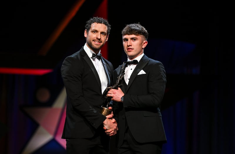 Clare hurler Adam Hogan is presented with the Young Hurler of the Year Award by Gaelic Players Association chief executive Tom Parsons. Photograph: Sam Barnes/Sportsfile