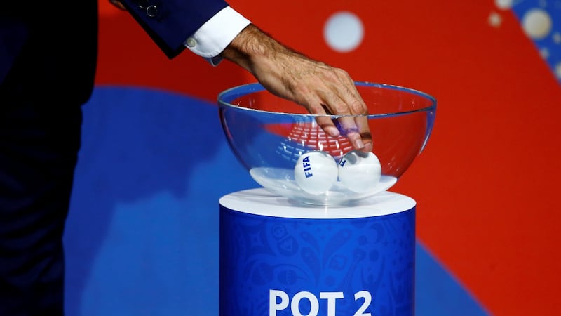 Former Spanish player Fernando Hierro shuffles the balls during the draw. Photograph: Arnd Wiegmann/Reuters