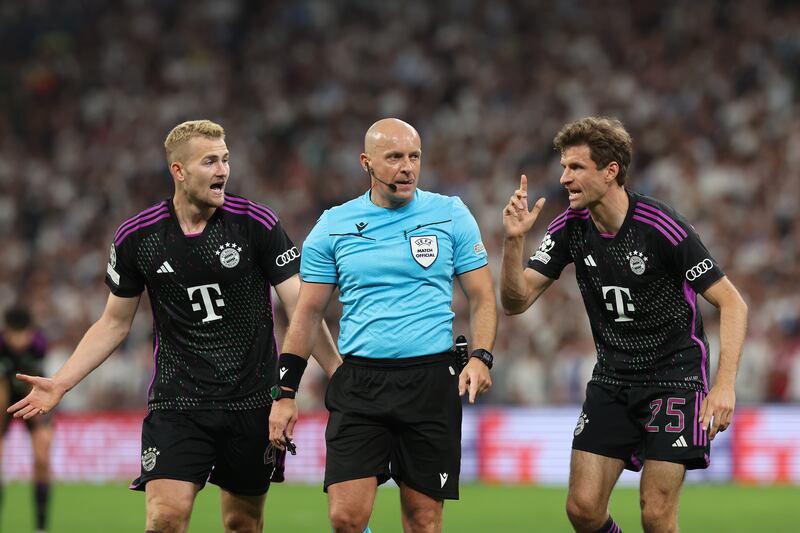 Referee Szymon Marciniak is confronted by Bayern Munich players  Matthijs de Ligt and Thomas Müller. Photograph: Alexander Hassenstein/Getty Images