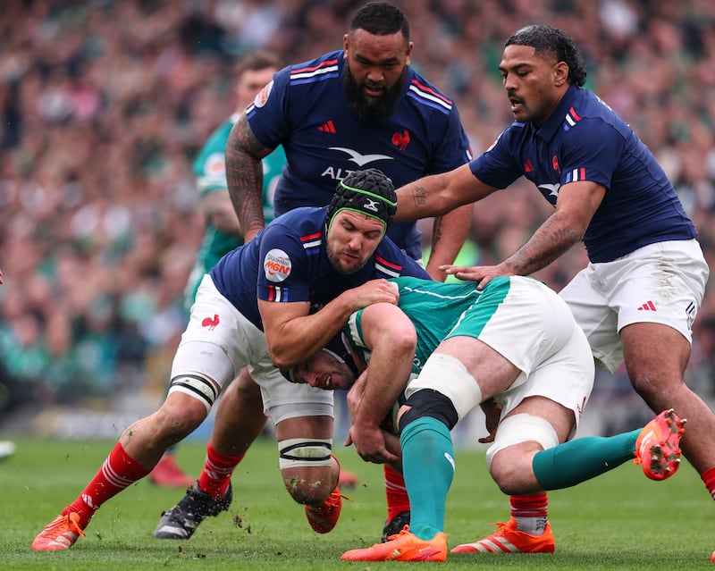 Ireland's Caelan Doris is tackled by France's Francois Cros, Uini Atonio and Peato Mauvaka. Photograph: Ben Brady/Inpho