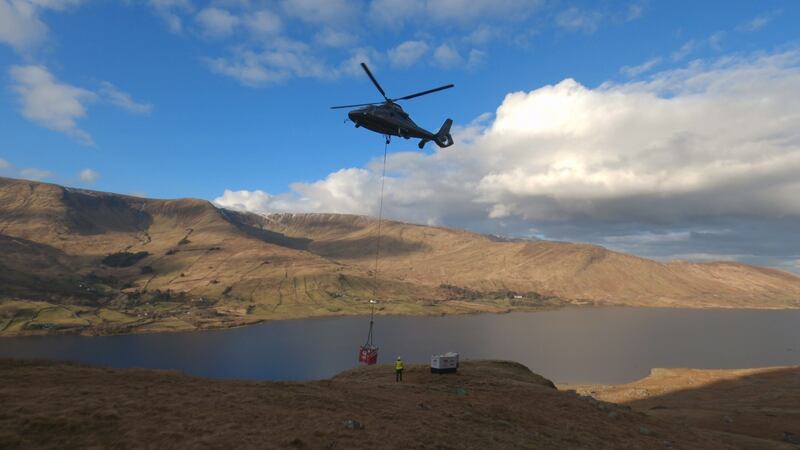 A helicopter drops generators into position on Connemara’s Ceann Garbh, to light 1,000 enormous lamps. The team is expected to film the illumination and distribute it on Saturday