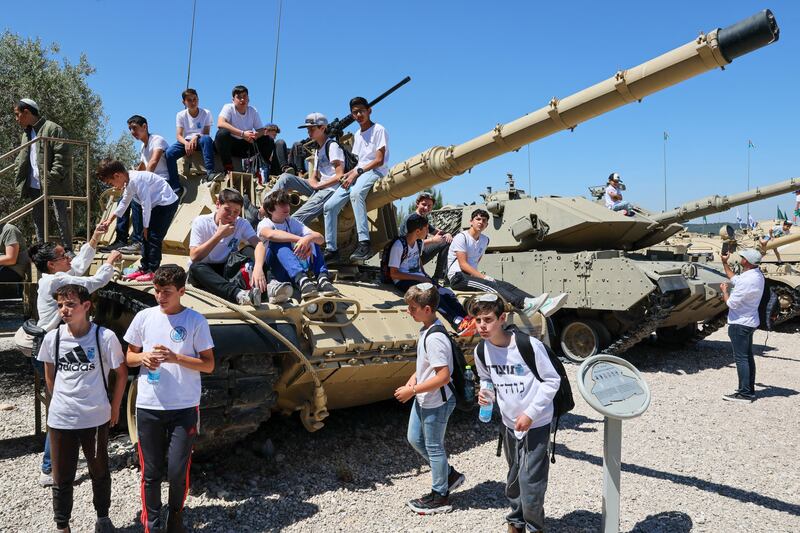 Children sit on a  tank at the Armoured Corps Memorial during a ceremonoy to  observe Memorial Day in Latrun, Israel. PhotographL Jack Guez/AFP via Getty Images