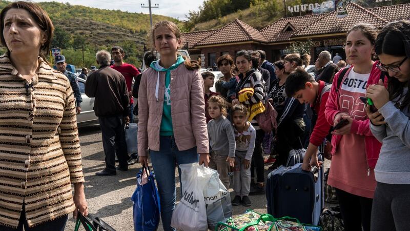 People gather at the edge of the city seeking rides in the direction of Yerevan, away from the fighting in Nagorno-Karabakh, on Tuesday. Photograph: Brendan Hoffman/Getty Images