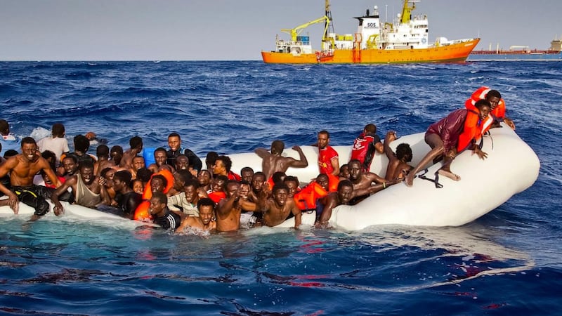 Migrants ask for help from a dinghy boat as they are approached by the SOS Mediterranee’s ship Aquarius, in background, off the coast of the Italian island of Lampedusa. Photograph: Patrick Bar/SOS Mediterranee via AP