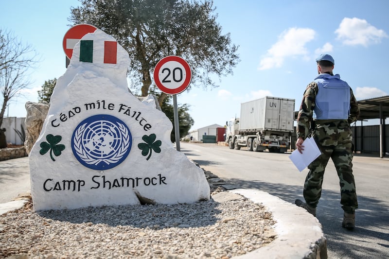 A peacekeeper walks past a sign greeting new arrivals to Camp Shamrock in south Lebanon. Photograph: Sally Hayden 