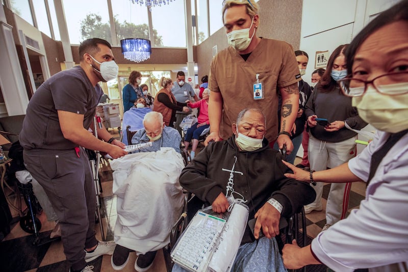 Residents are evacuated from a senior living facility in the path of one of the fires. Photograph: Ethan Swope/AP