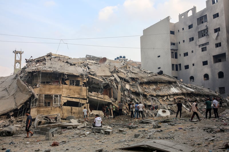 Residents inspect a damaged building after Israeli warplanes bombed Gaza City, Gaza Strip on Sunday, Oct. 8, 2023. Photograph: Samar Abu Elouf/The New York Times 