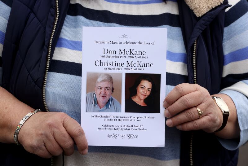 A mourner holds up the order of service following the funeral service for Dan and Christine McKane, showing their pictures on the front cover. Photograph: Liam McBurney/PA Wire