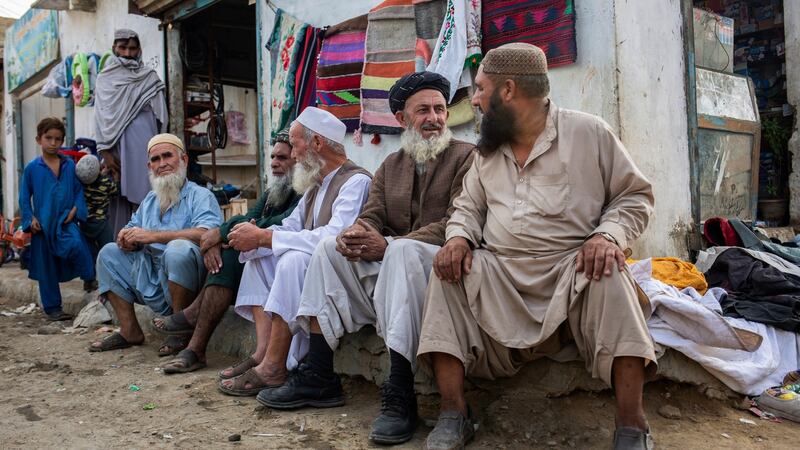 Men at Camp Jadeed, a makeshift home for Afghan refugees on the outskirts of Karachi, Pakistan. Photograph: Saiyna Bashir/The New York Times