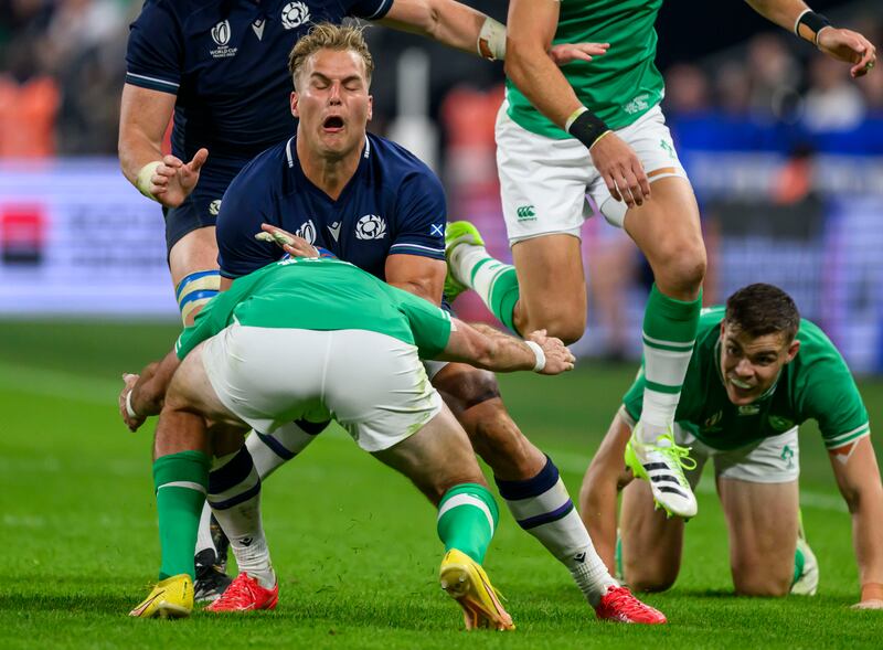 Scotland’s Duhan van der Merwe is tackled by Hugo Keenan of Ireland. 
                                