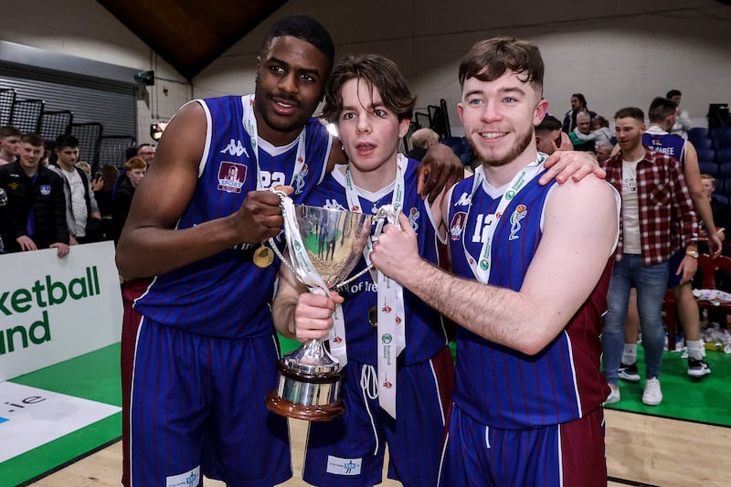 University of Galway Maree’s Mark Thiam, Comhghall McCormack and Matthew Sweeney celebrate with the Pat Duffy Cup at National Basketball Arena, Dublin. Photograph: Ben Brady/Inpho