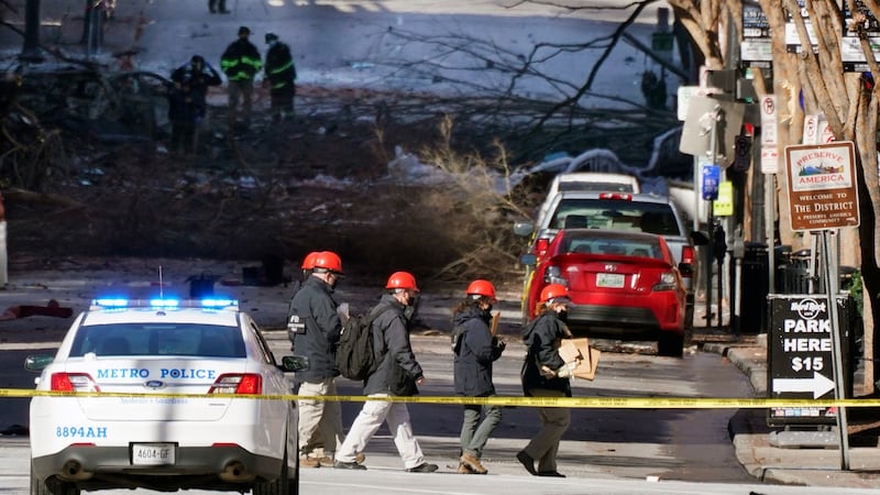 Investigators walk near the scene of the explosion in Nashville, Tennessee. Photograph: Mark Humphrey/AP Photo