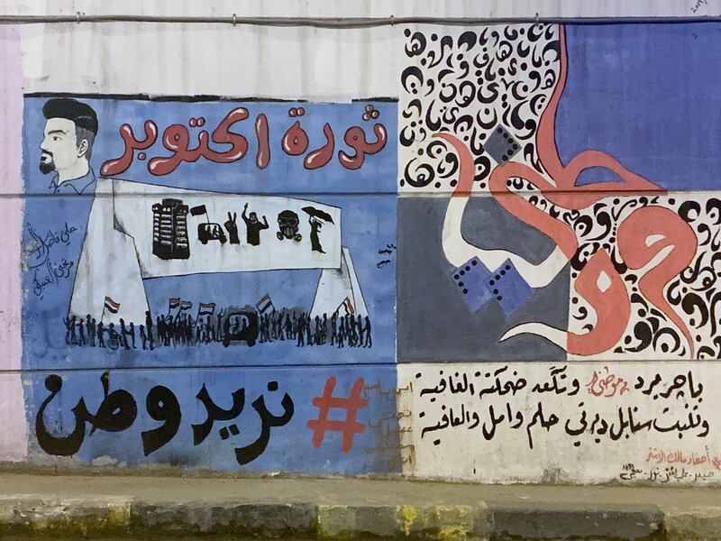 Graffiti on a Baghdad wall. "October revolution" in red, "We want a nation" (in black). Photograph: Lorraine Mallinder