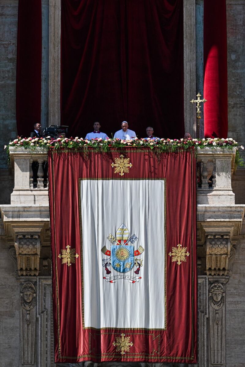 Pope Francis stands on the loggia at St Peter's Basilica overlooking St Peter's Square after delivering the Easter Urbi et Orbi message and blessing in The Vatican. Photograph: Andreas Solaro/AFP/Getty