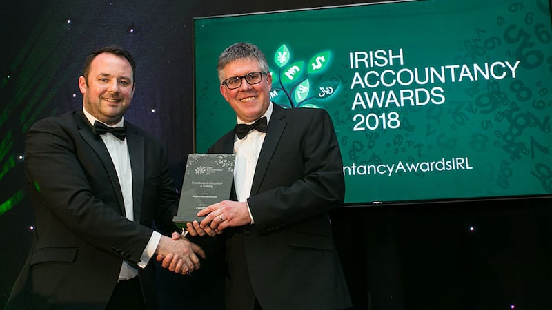 Micheal O’Neill, CEO, OmniPro presents the Excellence in Education & Training award to Dave O’Donoghue, Accountancyschool.ie