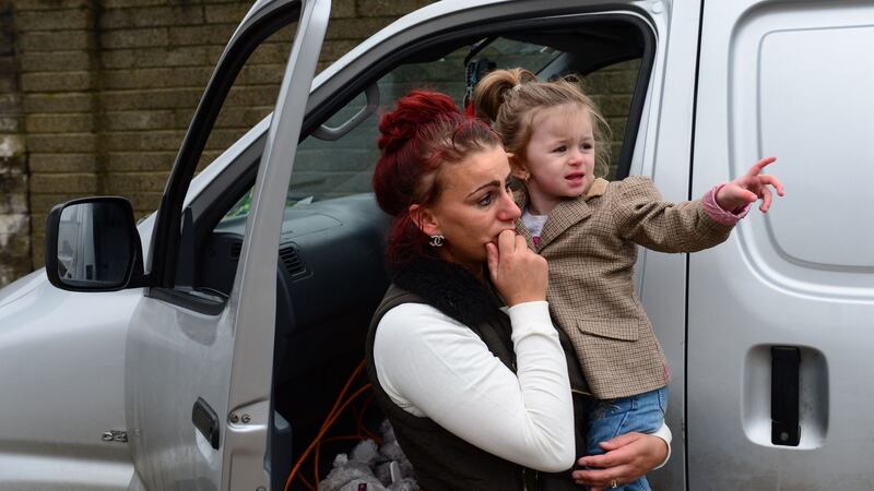 Ethel McDonagh and Lacey-Leah watch as their home was being removed for transportation.