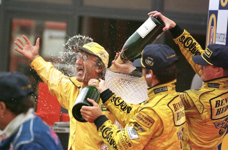 Belgian Formula One Grand Prix: Jordan team boss Eddie Jordan celebrates with Damon Hill and Ralf Schumacher after their first and second place victory in the  August 30th, 1998, race. Photograph: INPHO/Allsport