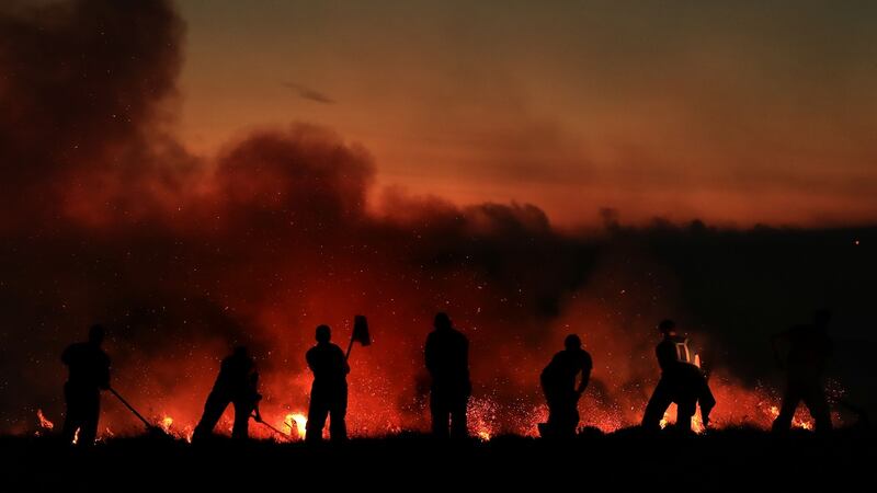 Firefighters tackle a wildfire on Winter Hill near Bolton. Photograph: Danny Lawson/PA Wire.