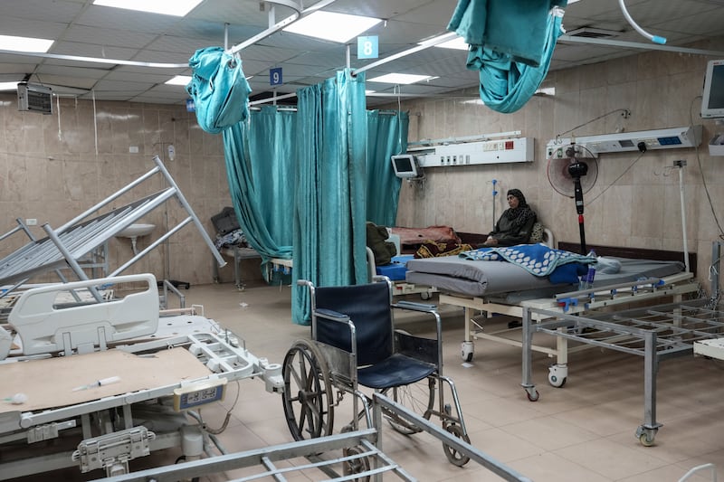 A woman sits on a bed in a room of the Al-Aqsa Martyrs hospital in Deir al Balah in Gaza. Photograph: Abdel Kareem Hana/AP