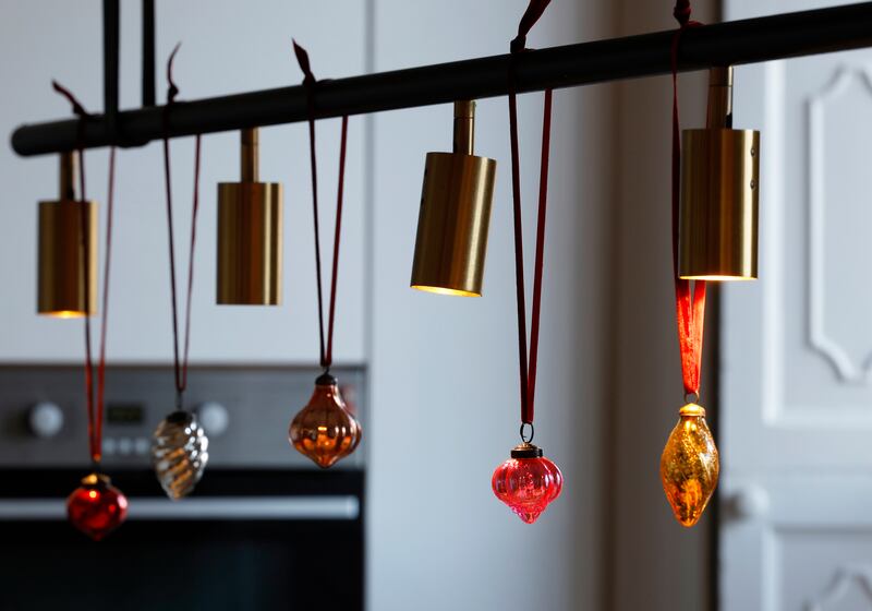 Kitchen: Baubles hanging from the long light that illuminates the island are the only adorment here. Photograph: Nick Bradshaw