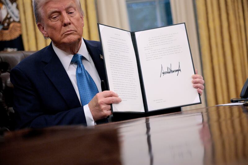 US president Donald Trump holds up an executive order, 'Unleashing prosperity through deregulation', which he signed in the Oval Office in January. Photograph: Chip Somodevilla/Getty Images