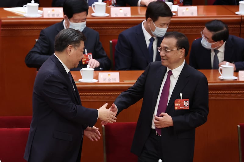 Chinese president Xi Jinping shakes hands with former premier Li Keqiang during the National People's Congress in Beijing in March. Photograph: Lintao Zhang/Getty Images