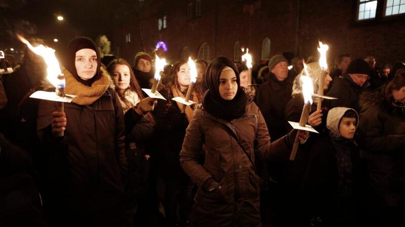 People carry torches during a memorial service in Copenhagen on Monday for victims of the deadly attacks on a synagogue and an event promoting free speech, in the Danish capital at the weekend. Thousands of Danes bearing lighted torches and flags braved icy wind to gather for a mass memorial on Monday. Photograph: Linda Kastrup/Reuters